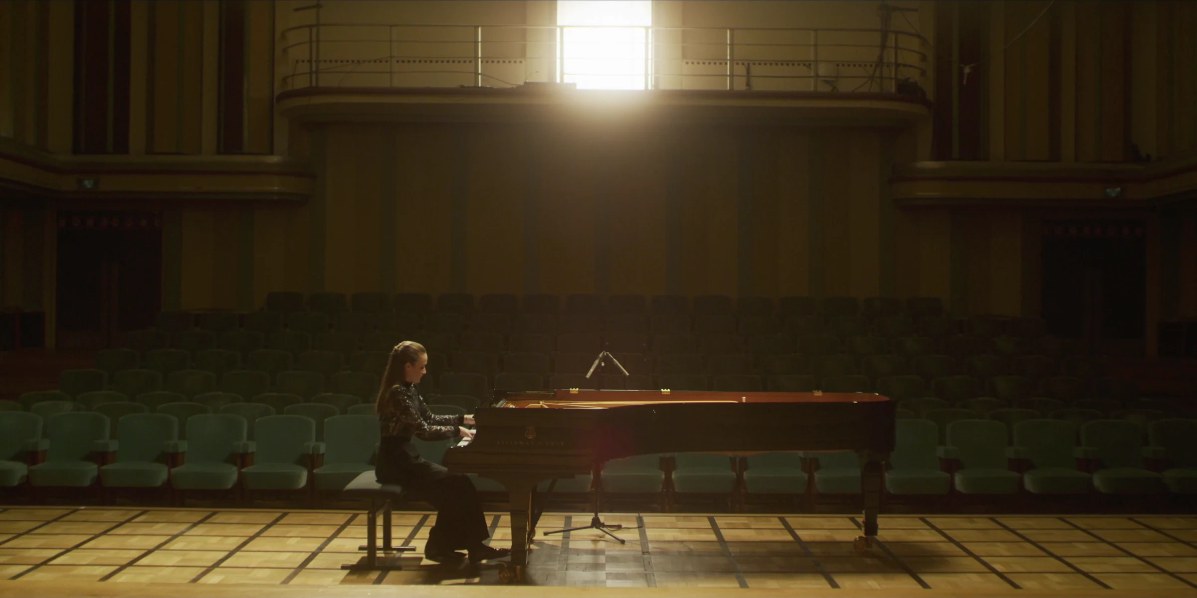 Pianist performing in a sunlit concert hall