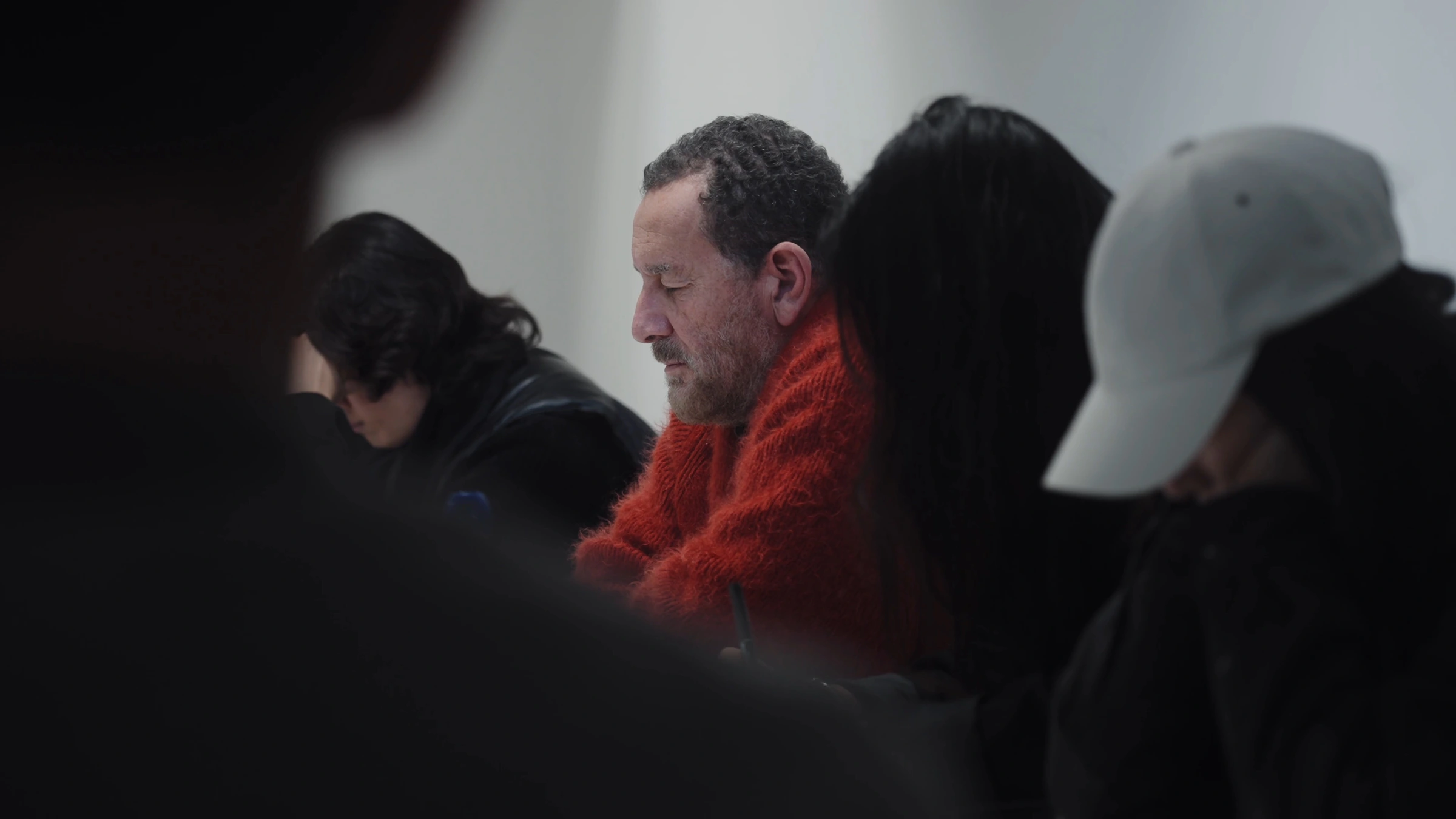Participants listening quietly around the table