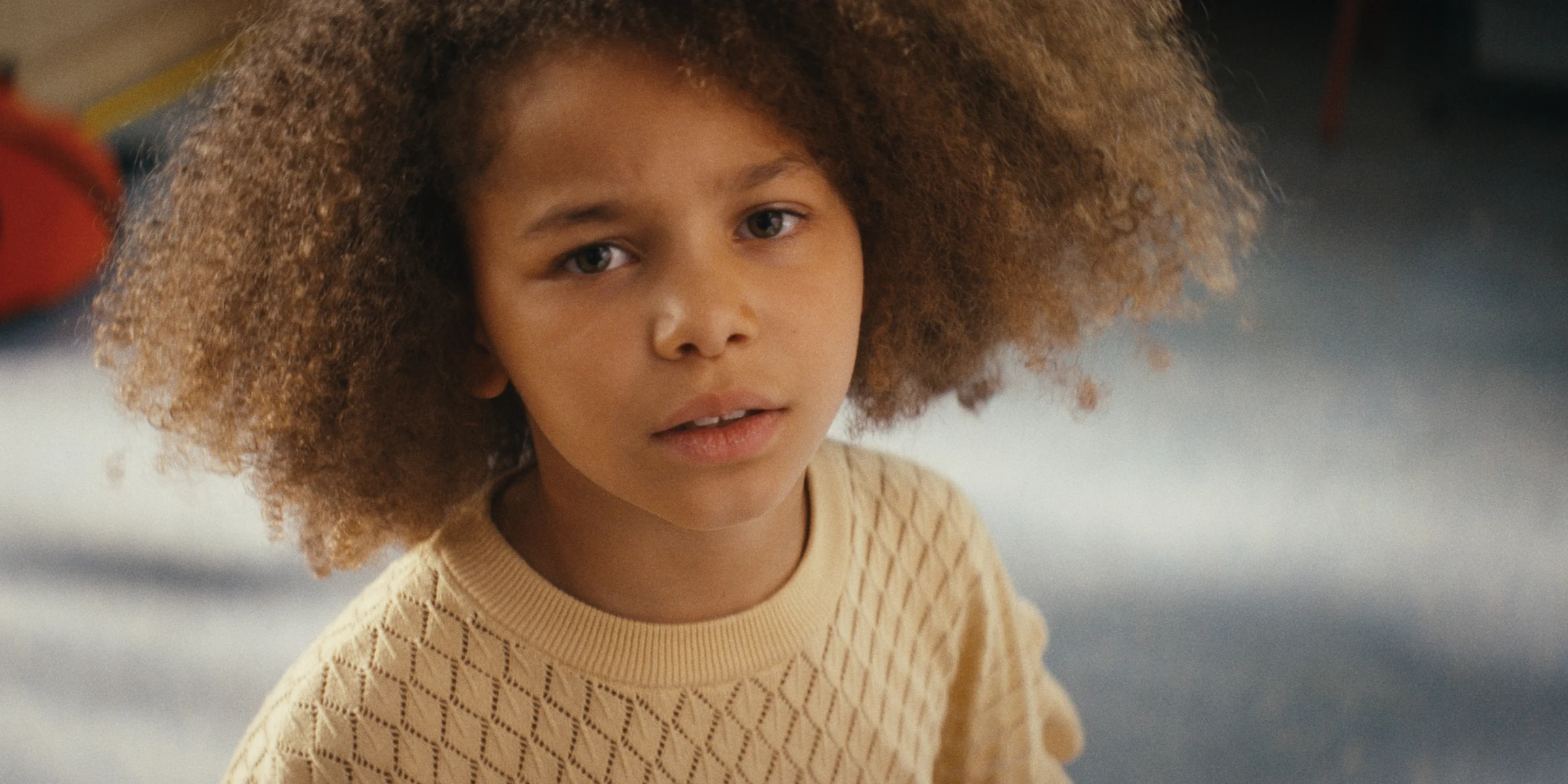 Portrait of a child in a cream sweater