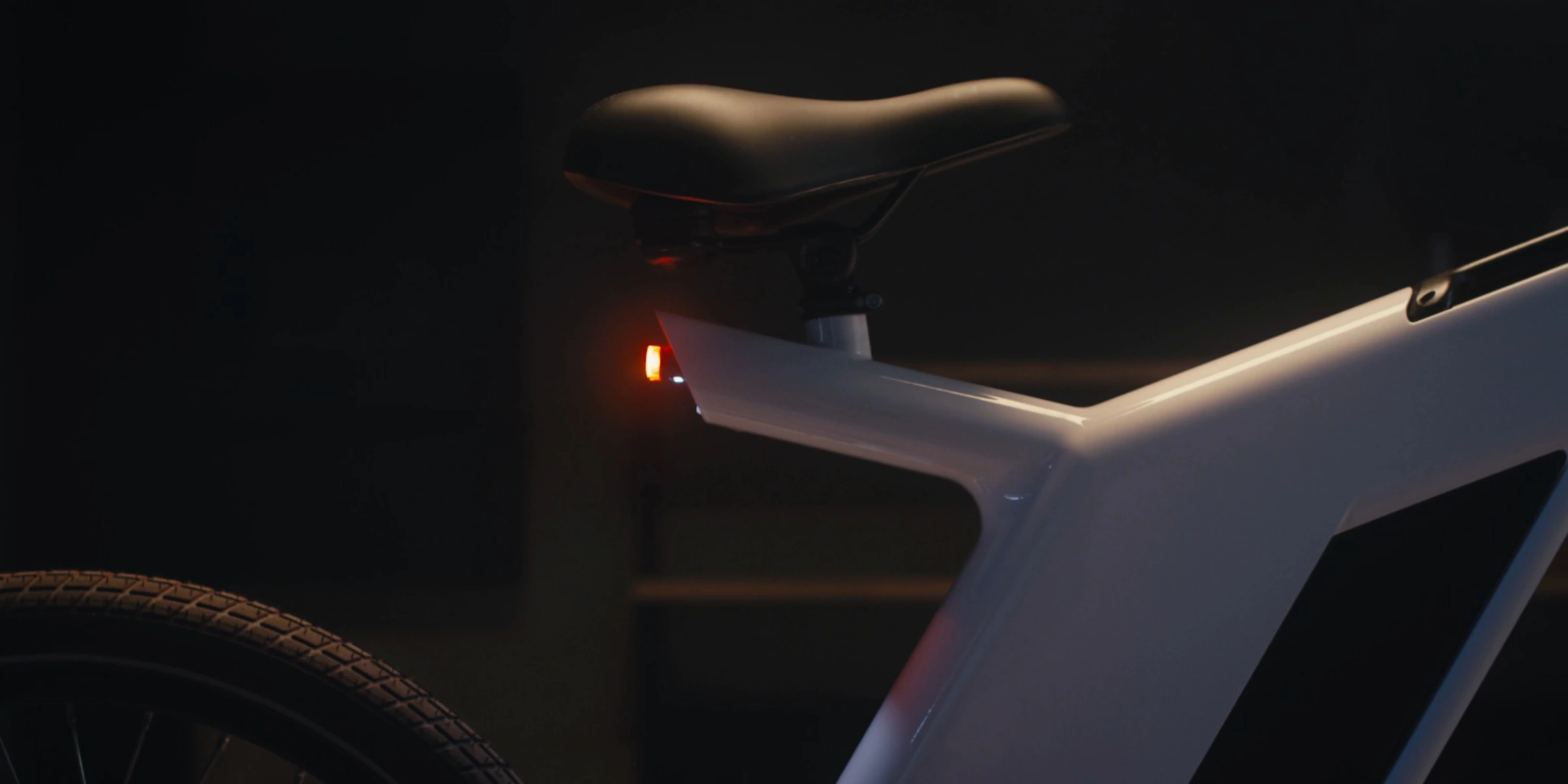 Bicycle saddle and rear light
