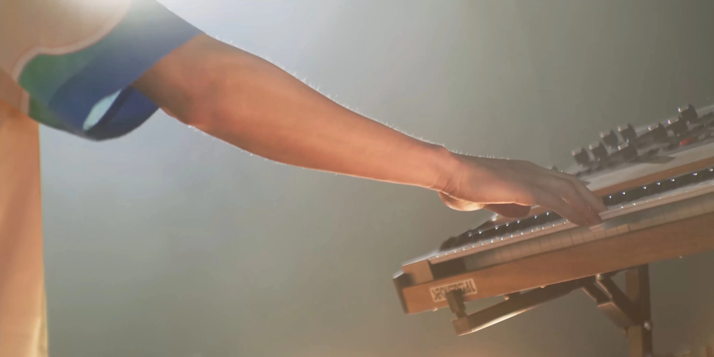 Close-up of a hand on an analogue synthesizer