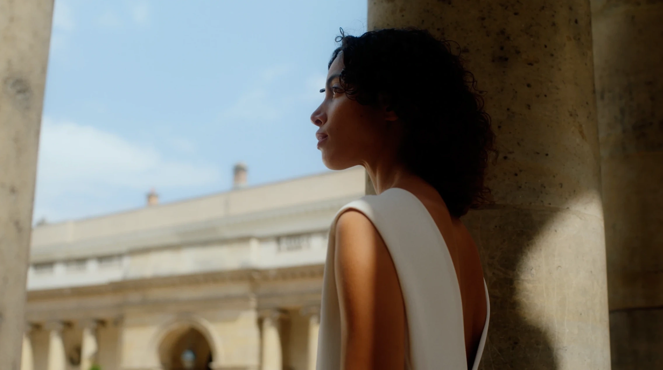 Portrait beside a stone column