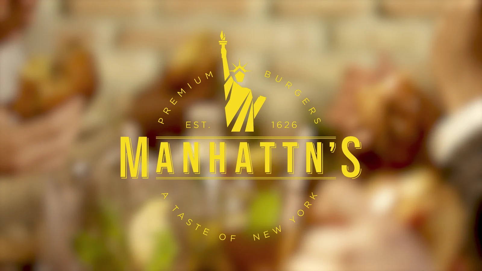 Manhattn’s Burger — yellow logo over a warm restaurant scene