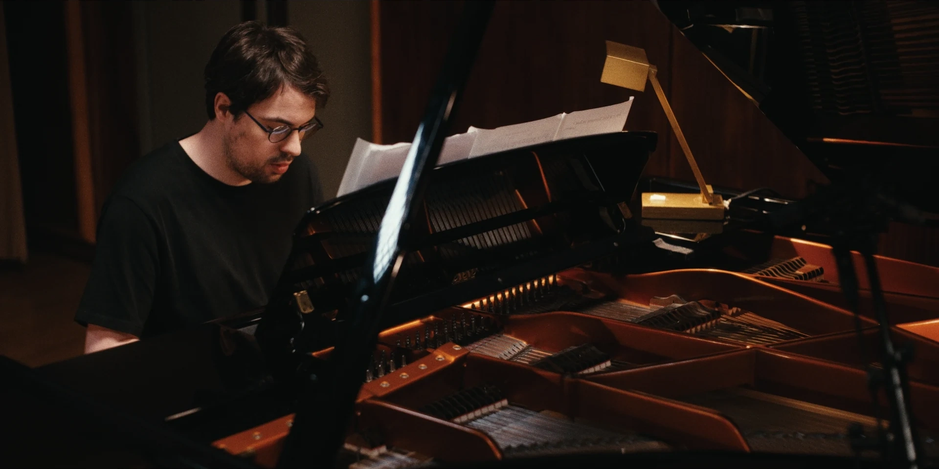Pianist framed by the open grand piano