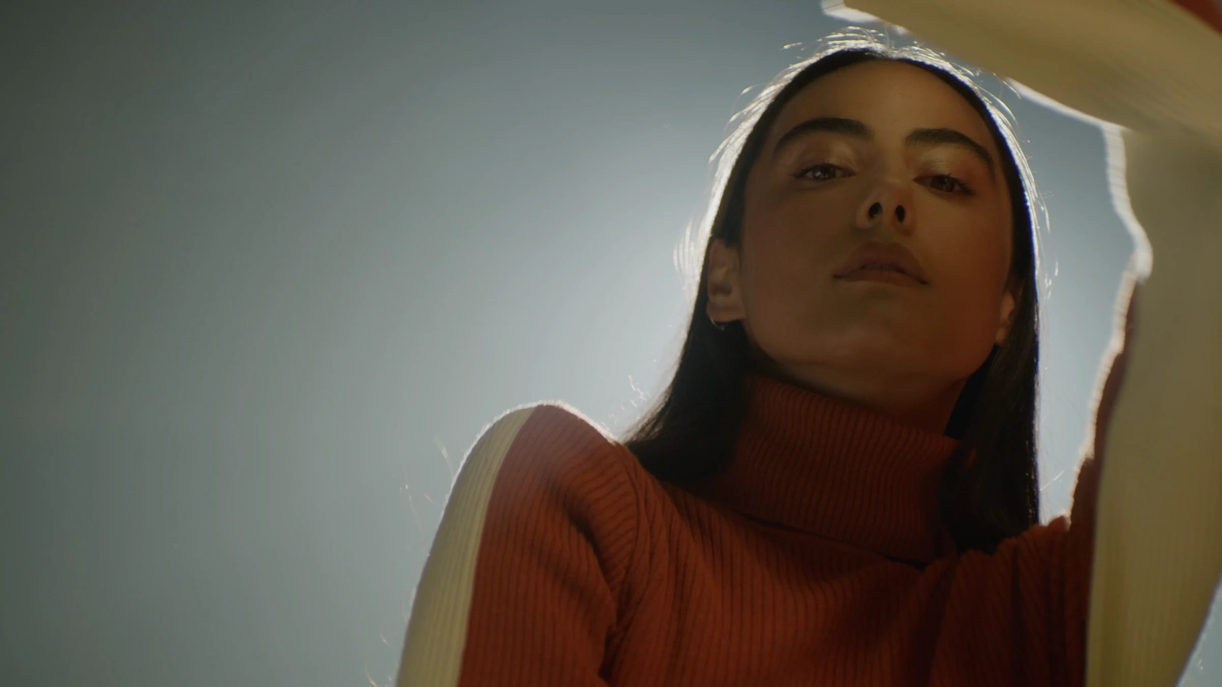 Portrait in an orange and cream knit