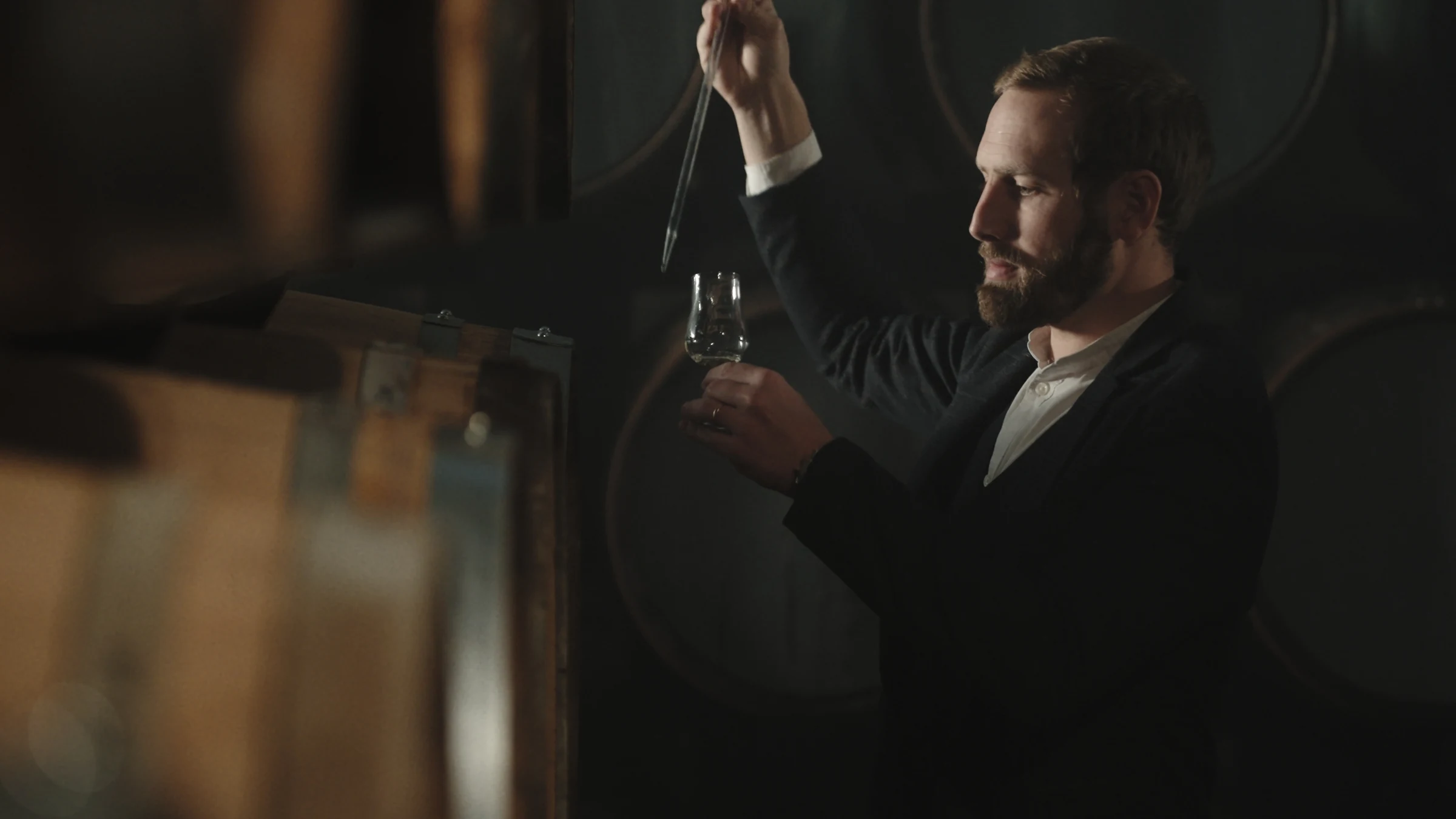 Drawing a whisky sample in the cellar
